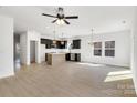 Open-concept living space with modern lighting and light-colored flooring at 544 Church St, Locust, NC 28097