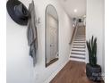 Bright entryway features wood-look floors, coat hooks, decorative mirror and staircase at 5516 Swaling St, Charlotte, NC 28217