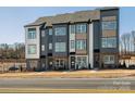 New townhouse exteriors feature modern design with a mix of siding and brick accents at 5516 Swaling St, Charlotte, NC 28217