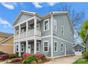Side view of a two-story home featuring a small balcony, driveway, and detached garage at 612 Baldwin Ave, Charlotte, NC 28204
