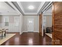 Inviting foyer with hardwood floors, elegant trim, and a stylish sliding barn door at 612 Baldwin Ave, Charlotte, NC 28204