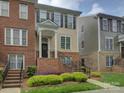Charming townhouse with brick and siding facade, steps leading to the entrance, and lush greenery at 668 Sixth Baxter Xing, Fort Mill, SC 29708
