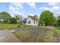 Well-maintained exterior with a gravel driveway and a quaint, fenced yard at 745 6Th Sw Ave, Hickory, NC 28602