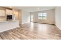 Bright open-concept living room showcasing wood flooring, natural light, and a view of the backyard at 8432 Norman Forest Rd, Lancaster, SC 29720