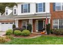 Inviting front porch with decorative plants enhancing the curb appeal of this charming brick home at 8929 Lizzie Ln, Huntersville, NC 28078