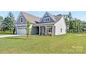 Attractive home with a landscaped lawn and a welcoming porch, offering curb appeal and charm at 908 Cypress Point Ln # 218, Monroe, NC 28112