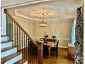 Formal dining room featuring decorative chandelier and tray ceiling adds a touch of elegance to the home at 9508 Hayenridge Ct, Huntersville, NC 28078