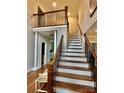 Welcoming two-story foyer with hardwood floors and staircase with iron balusters provides an elegant entry at 9508 Hayenridge Ct, Huntersville, NC 28078