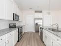 Modern kitchen with stainless steel appliances, granite countertops, ample white cabinetry, and functional design at 105 Tanner Loop, Troutman, NC 28166