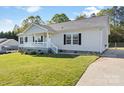 Charming single-story home with a well-maintained lawn and inviting front porch at 1058 Canada Dr, Dallas, NC 28034