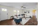 Bright living room featuring hardwood floors, a white couch, and modern decor for a welcoming atmosphere at 1058 Canada Dr, Dallas, NC 28034