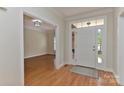 Bright foyer with hardwood floors offers a glimpse into the adjacent living area, creating a welcoming ambiance at 1090 Heather Glen Dr, Matthews, NC 28104