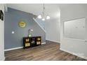 Open foyer with hardwood floors, neutral paint, hall tree, and an open staircase at 11040 E Lake Rd, Charlotte, NC 28215