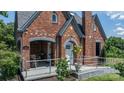 Close-up of brick home's front porch with seating and flowers creating a warm entrance at 115 12Th Sw St, Hickory, NC 28602