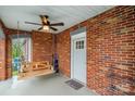 Cozy front porch featuring brick walls, a porch swing, and a ceiling fan at 115 12Th Sw St, Hickory, NC 28602