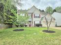 Inviting home with a well maintained lawn and landscaping with decorative trees at 119 W Maranta Rd, Mooresville, NC 28117