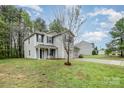 Inviting two-story home with lush greenery and a well-maintained lawn, creating a peaceful outdoor space at 1213 Salvadore Ct, Gastonia, NC 28052