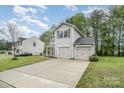 Attractive home featuring a spacious driveway and attached two-car garage nestled in a serene neighborhood at 1213 Salvadore Ct, Gastonia, NC 28052