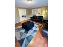 This living room features wood floors, neutral walls, and a dark leather furniture set at 124 Riley Rd, Dallas, NC 28034