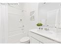 Bright bathroom featuring a shower-tub combo, a white vanity with sink, and neutral decor at 1324 Secrest Commons Dr, Monroe, NC 28112