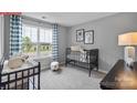 Cozy Bedroom features a crib, changing table, and a large window at 1328 Secrest Commons Dr, Monroe, NC 28112