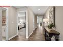 Inviting hallway with wood floors, neutral paint, and an open view of the home at 1328 Secrest Commons Dr, Monroe, NC 28112