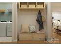 Functional mudroom area with bench, hooks, shelving, neutral pillows, and laundry appliances visible at 1552 Croydon St, Indian Land, SC 29707