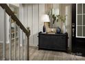 Stylish entryway features a decorative table, a mirror, and a staircase, creating an inviting space at 1619 Honey Trl, Monroe, NC 28112