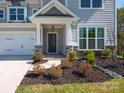 Charming front entrance with stone accents and lush landscaping creates an inviting and welcoming feel at 2108 Sabra St, Gastonia, NC 28054