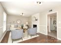 Bright living room featuring hardwood floors, a fireplace, neutral paint, and stylish decor at 2413 Bergen Ct, Charlotte, NC 28210