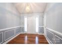 Bright foyer featuring hardwood floors, wainscoting, and elegant lighting at 2426 36Th Ne Ave, Hickory, NC 28601