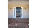 Close-up of the front door with sidelights and brickwork, creating a welcoming entrance at 2426 36Th Ne Ave, Hickory, NC 28601