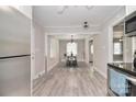 Open-concept dining area with hardwood floors, stylish lighting, and views into the living space at 2825 Old Pageland Marshville Rd, Wingate, NC 28174