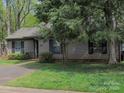Cozy home with mature trees, healthy lawn, and comfortable, friendly curb appeal at 380 Sweetgum Dr, Fort Mill, SC 29715