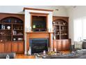 Inviting living room with a fireplace and custom wood built-ins, perfect for cozy evenings at 447 Shagbark Ct, Mount Gilead, NC 27306