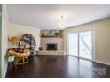 Inviting living room featuring a brick fireplace, wood floors, and sliding glass doors at 507 Texas Trl, Dallas, NC 28034