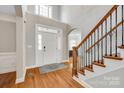 Bright foyer with hardwood floors, elegant staircase, and soaring ceilings showcasing a grand entrance at 5103 Trinity Trace Ln, Monroe, NC 28110