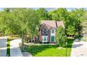 Two-story brick home with lush trees, green lawn, and a manicured landscape at 62 Pond View Ln, Fort Mill, SC 29715