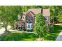 A slightly elevated shot of a brick home with well-kept lawn and mature landscaping at 62 Pond View Ln, Fort Mill, SC 29715