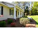 Inviting front porch with brick accents, offering a cozy space to relax and enjoy the outdoors at 6779 Highway 557 Hwy, Clover, SC 29710
