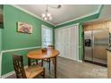 Cozy dining area featuring light gray floors, green walls, and an oval table for Gathering meals at 6809 Copernicus Cir, Charlotte, NC 28226