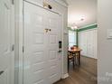 Inviting entryway featuring a charming wooden table and chairs, creating a welcoming and functional space at 6809 Copernicus Cir, Charlotte, NC 28226