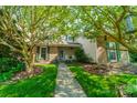 Inviting townhome with mature trees, traditional green shutters, a cozy front porch, and a well-manicured lawn at 6809 Copernicus Cir, Charlotte, NC 28226