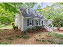 Side view showcasing a charming two-story home with tidy landscaping and a welcoming entrance at 7514 Pewter Ln, Charlotte, NC 28270