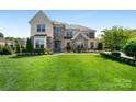 Charming home with lush lawn, stone accents, and well-maintained landscaping creates curb appeal at 9611 Pensive Ln, Waxhaw, NC 28173