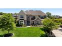 Elegant home boasts a lush green lawn, stone and brick facade, and mature trees at 9611 Pensive Ln, Waxhaw, NC 28173