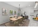 Bright dining area with stylish light fixture, table with six chairs, and scenic window view at 1041 Secor St, Statesville, NC 28677