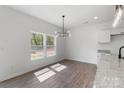 Dining area with a light fixture, view to a window, and access to the kitchen at 1041 Secor St, Statesville, NC 28677