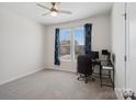 Bedroom with a ceiling fan and window with blue patterned curtains, and computer desk at 1045 Cavalier Ln, Rock Hill, SC 29730