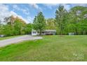 Vast lawn with mature trees, offering a serene and private outdoor setting for this charming home at 1106 University Dr, Lancaster, SC 29720